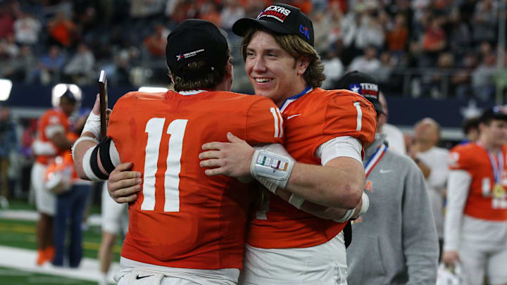 Celina's Luke Biagini (11), the defensive MVP, hugs Bowe Bentley, the offensive MVP, after the Class 4A, Division I State Championship game on Friday, Dec. 20, 2024, at AT&T Stadium in Arlington, Texas.
