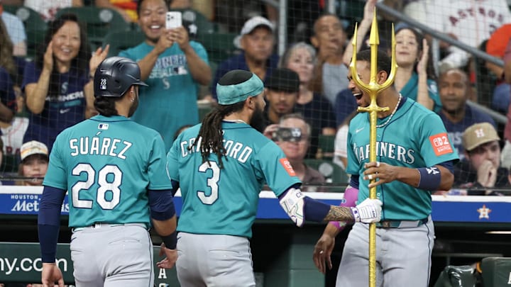Sep 21, 2025; Houston, Texas, USA; Seattle Mariners shortstop J.P. Crawford (3) grabs the trident from right fielder Victor Robles (10) after he hit a grand slam against the Houston Astros in the second inning at Daikin Park. Mandatory Credit: Thomas Shea-Imagn Images Sep 21, 2025; Houston, Texas, USA; Seattle Mariners shortstop J.P. Crawford (3) grabs the trident from right fielder Victor Robles (10) after he hit a grand slam against the Houston Astros in the second inning at Daikin Park. Mandatory Credit: Thomas Shea-Imagn Images