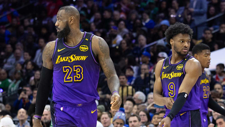 Los Angeles Lakers forward LeBron James (23) and guard Bronny James (9) look on during the third quarter against the Philadelphia 76ers at Wells Fargo Center. 