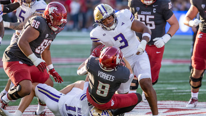 Buddah Al-Uqdah and Alex McLaughlin make an Apple Cup tackle.