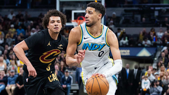 Apr 10, 2025; Indianapolis, Indiana, USA; Indiana Pacers guard Tyrese Haliburton (0) dribbles the ball while Cleveland Cavaliers guard Craig Porter Jr. (9) defends in the second half at Gainbridge Fieldhouse. Mandatory Credit: Trevor Ruszkowski-Imagn Images