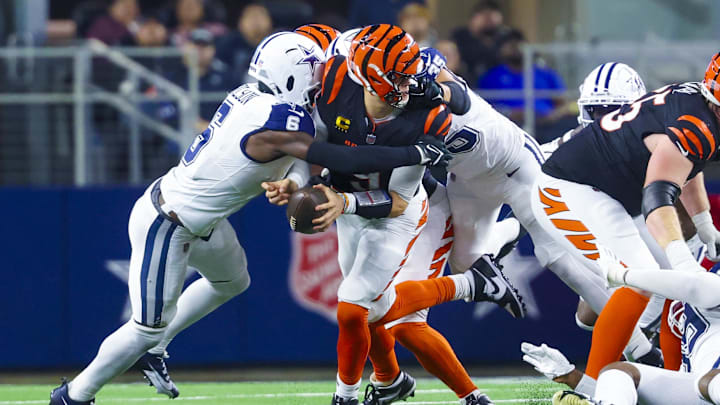 Dec 9, 2024; Arlington, Texas, USA;  Dallas Cowboys safety Donovan Wilson (6) tackles Cincinnati Bengals quarterback Joe Burrow (9) during the second half at AT&T Stadium. Mandatory Credit: Kevin Jairaj-Imagn Images