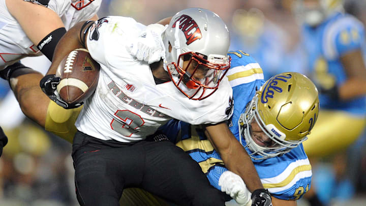 September 10, 2016; Pasadena, CA, USA; UNLV Rebels running back Lexington Thomas (3) runs the ball against the defense of UCLA Bruins defensive lineman Jacob Tuioti-Mariner (91) during the second half at Rose Bowl. Mandatory Credit: Gary A. Vasquez-Imagn Images
September 10, 2016; Pasadena, CA, USA; UNLV Rebels running back Lexington Thomas (3) runs the ball against the defense of UCLA Bruins defensive lineman Jacob Tuioti-Mariner (91) during the second half at Rose Bowl. Mandatory Credit: Gary A. Vasquez-Imagn Images