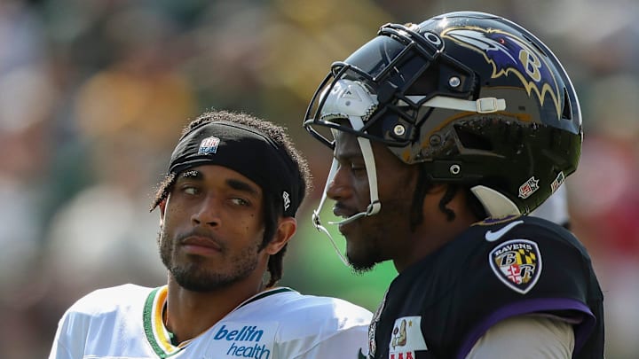 Green Bay Packers cornerback Jaire Alexander talks with Baltimore Ravens quarterback Lamar Jackson.