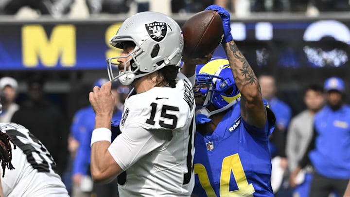 Oct 20, 2024; Inglewood, California, USA; Los Angeles Rams cornerback Cobie Durant (14) knocks the ball out of the hands of Las Vegas Raiders quarterback Gardner Minshew (15) during the second quarter at SoFi Stadium. The ball was recovered by Los Angeles Rams safety Kamren Curl (3) and runback for a touchdown. Mandatory Credit: Robert Hanashiro-Imagn Images