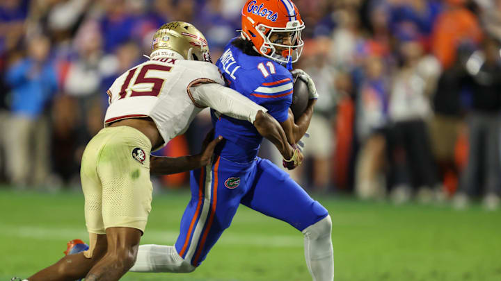 Florida wide receiver Aidan Mizell (11) makes yards against Florida defensive lineman Jayden Woods (15) during the second half of an NCAA football game at Steve Spurrier Field at Ben Hill Griffin Stadium in Gainesville, FL on Saturday, November 29, Florida beat Florida State 40-21.2025. [Alan Youngblood/Gainesville Sun]