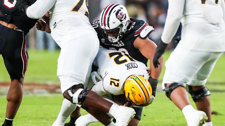 Nov 16, 2024; Columbia, South Carolina, USA; South Carolina Gamecocks defensive tackle T.J. Sanders (90) sacks Missouri Tigers quarterback Brady Cook (12) in the second quarter