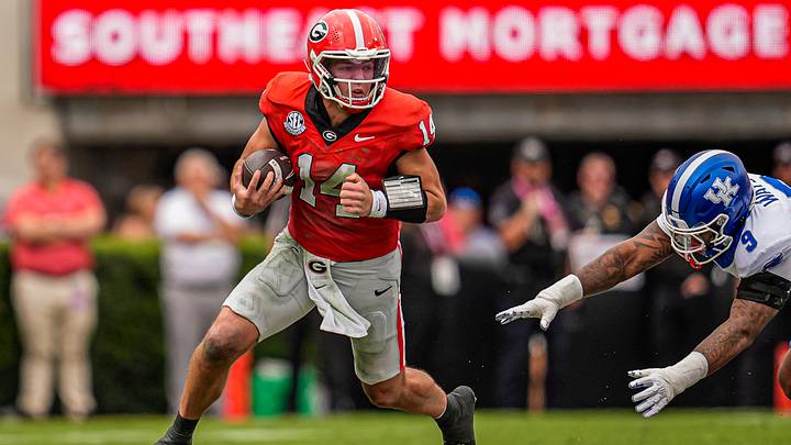Oct 4, 2025; Athens, Georgia, USA; Georgia Bulldogs quarterback Gunner Stockton (14) breaks a tackle by Kentucky Wildcats linebacker Landyn Watson (9) during the first quarter at Sanford Stadium. Mandatory Credit: Dale Zanine-Imagn Images