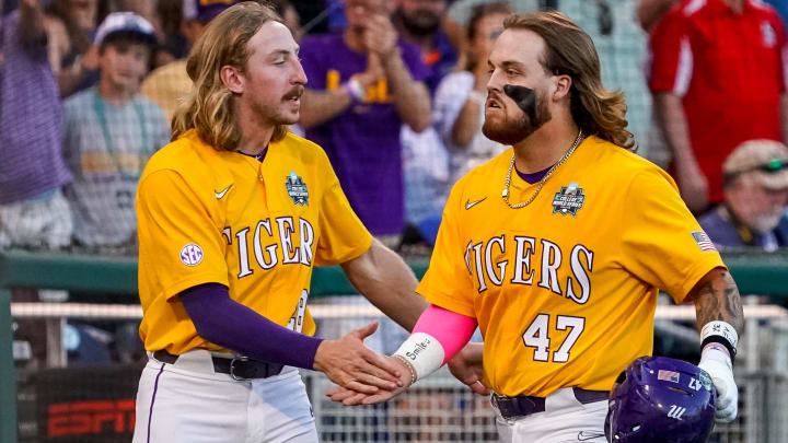 Jun 24, 2023; Omaha, NE, USA; LSU Tigers third baseman Tommy White (47) and right fielder Paxton Kling (28) celebrate after a home run by White against the Florida Gators during the eighth inning at Charles Schwab Field Omaha. Mandatory Credit: Dylan Widger-USA TODAY Sports