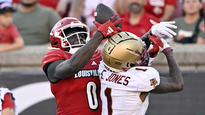 Sep 23, 2023; Louisville, Kentucky, USA; Louisville Cardinals wide receiver Chris Bell (0) attempts to catch a pass over Boston College Eagles defensive back Elijah Jones (1) during the second half at L&N Federal Credit Union Stadium. Louisville defeated Boston College 56-28. Mandatory Credit: Jamie Rhodes-Imagn Images Sep 23, 2023; Louisville, Kentucky, USA; Louisville Cardinals wide receiver Chris Bell (0) attempts to catch a pass over Boston College Eagles defensive back Elijah Jones (1) during the second half at L&N Federal Credit Union Stadium. Louisville defeated Boston College 56-28. Mandatory Credit: Jamie Rhodes-Imagn Images