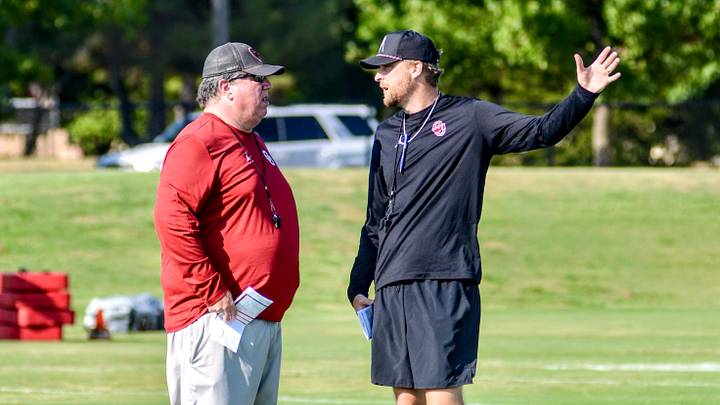 Oklahoma offensive line coach Bill Bedenbaugh talks to offensive coordinator Ben Arbuckle during practice. Oklahoma offensive line coach Bill Bedenbaugh talks to offensive coordinator Ben Arbuckle during practice.