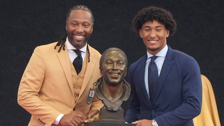 Pro Football Hall of Fame enshrinee Larry Fitzgerald and his son Devin Fitzgerald pose with his bust during the Class of 2026 enshrinement ceremony at Tom Benson Hall of Fame Stadium in Canton, Ohio, on Aug. 8, 2026. Pro Football Hall of Fame enshrinee Larry Fitzgerald and his son Devin Fitzgerald pose with his bust during the Class of 2026 enshrinement ceremony at Tom Benson Hall of Fame Stadium in Canton, Ohio, on Aug. 8, 2026.
