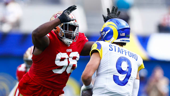 San Francisco 49ers defensive tackle Javon Hargrave (98) and Los Angeles Rams quarterback Matthew Stafford (9)