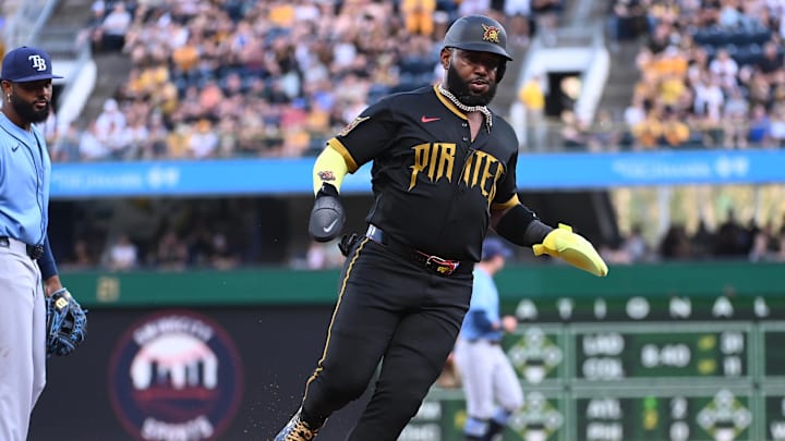 Apr 17, 2026; Pittsburgh, Pennsylvania, USA;  Pittsburgh Pirates designated hitter Marcell Ozuna passes Tampa Bay Rays third baseman Junior Caminero to score during the second inning at PNC Park. Mandatory Credit: Philip G. Pavely-Imagn Images