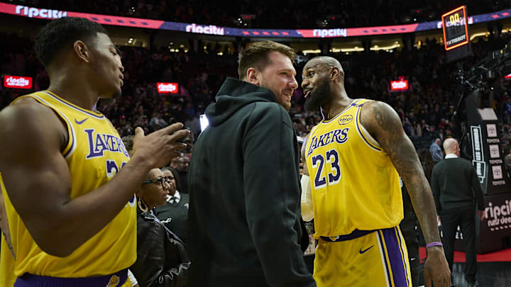 Feb 20, 2025; Portland, Oregon, USA; Los Angeles Lakers forward LeBron James (23) celebrates with guard Luka Doncic (77) and forward Rui Hachimura (28) after beating the Portland Trail Blazers at Moda Center. Mandatory Credit: Troy Wayrynen-Imagn Images