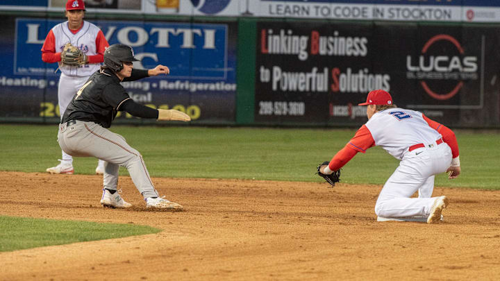 Modesto Nuts shortstop Colt Emerson (left) avoids a tag during a game against the Stockton Ports on April 5 at Stockton Ballpark. Modesto Nuts shortstop Colt Emerson (left) avoids a tag during a game against the Stockton Ports on April 5 at Stockton Ballpark.