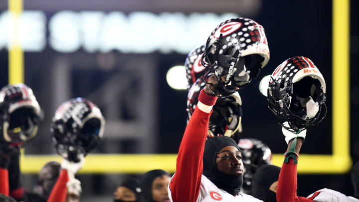 Glenville High School football quarterback Deonte Rucker holds his helmet high before kickoff against Wyoming High School in the OHSAA State Division IV Football Championship game at Tom Benson Hall of Fame Stadium.  Saturday, December 3, 2022.

Community 27