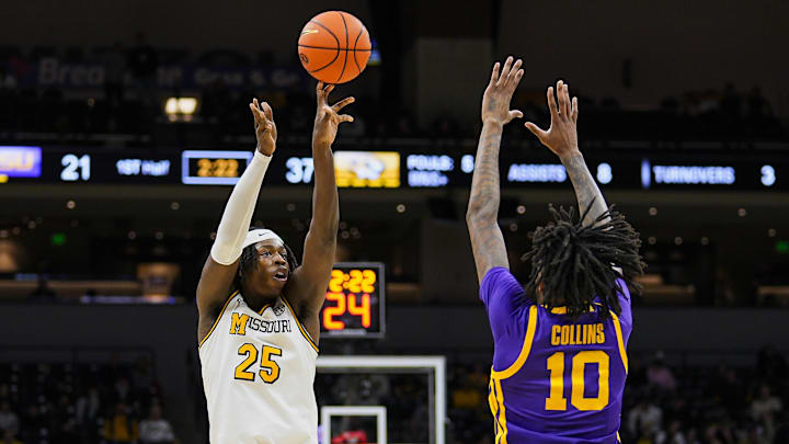 Jan 7, 2025; Columbia, Missouri, USA; Missouri Tigers guard Mark Mitchell (25) shoots against LSU Tigers forward Daimion Collins (10) during the first half at Mizzou Arena. Mandatory Credit: Jay Biggerstaff-Imagn Images