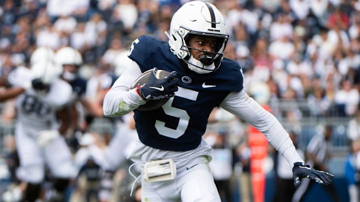 Penn State wide receiver Devonte Ross (5) runs with the ball during the Blue-White Game at Beaver Stadium.