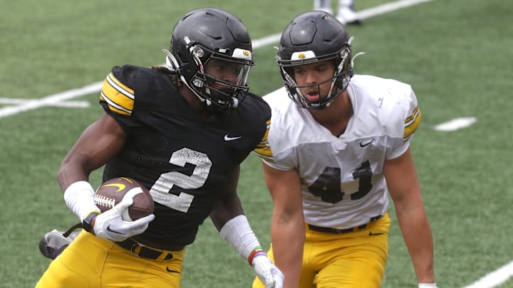 Iowa Hawkeyes running back Kaleb Johnson (2) is defended by linebacker Jaden Harrell (41) during an open spring practice Saturday, April 20, 2024 at Kinnick Stadium in Iowa City, Iowa.