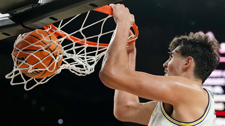Apr 6, 2026; Indianapolis, IN, USA; Michigan Wolverines center Aday Mara (15) dunks against the UConn Huskies during the second half in the national championship of the Final Four of the men's 2026 NCAA Tournament between the  and the Michigan Wolverines at Lucas Oil Stadium.