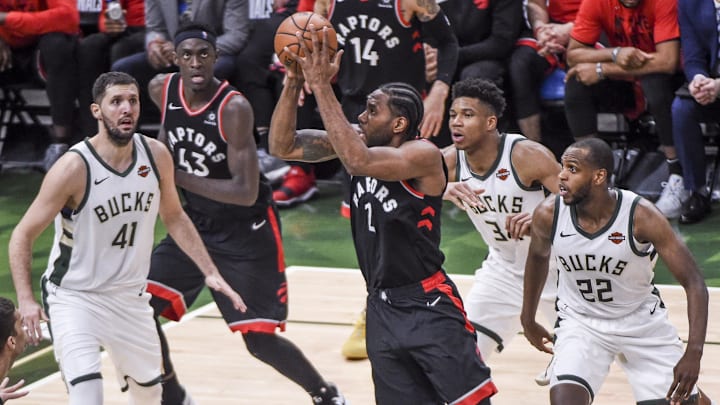 May 15, 2019; Milwaukee, WI, USA; Toronto Raptors forward Kawhi Leonard (2) takes a shot against Milwaukee Bucks forward Nikola Mirotic (41), forward Giannis Antetokounmpo (34) and forward Khris Middleton (22) in the third quarter in game one of the Eastern conference finals of the 2019 NBA Playoffs at Fiserv Forum. Mandatory Credit: Benny Sieu-Imagn Images May 15, 2019; Milwaukee, WI, USA; Toronto Raptors forward Kawhi Leonard (2) takes a shot against Milwaukee Bucks forward Nikola Mirotic (41), forward Giannis Antetokounmpo (34) and forward Khris Middleton (22) in the third quarter in game one of the Eastern conference finals of the 2019 NBA Playoffs at Fiserv Forum. Mandatory Credit: Benny Sieu-Imagn Images