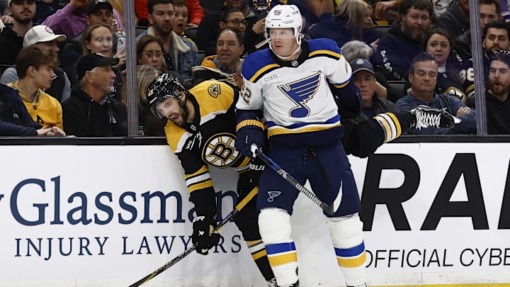 Nov 16, 2024; Boston, Massachusetts, USA; St. Louis Blues defenseman Ryan Suter (22) checks Boston Bruins center Mark Kastelic (47) into the boards during the first period at TD Garden. Mandatory Credit: Winslow Townson-Imagn Images