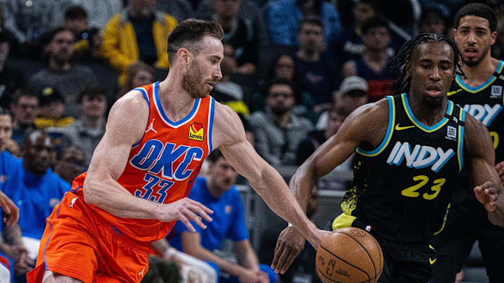 Apr 5, 2024; Indianapolis, Indiana, USA; Oklahoma City Thunder forward Gordon Hayward (33) dribbles the ball while Indiana Pacers forward Aaron Nesmith (23) defends in the first half at Gainbridge Fieldhouse. Mandatory Credit: Trevor Ruszkowski-USA TODAY Sports