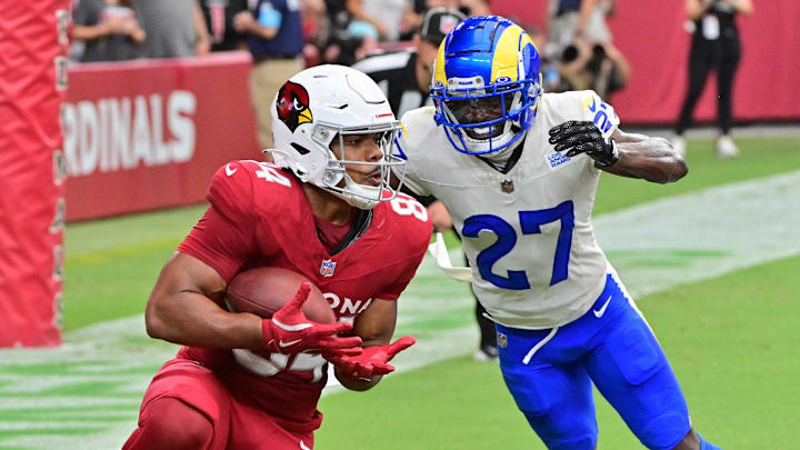 Sep 15, 2024; Glendale, Arizona, USA;  Arizona Cardinals tight end Elijah Higgins (84) catches a touchdown  as Los Angeles Rams cornerback Tre'Davious White (27) defends