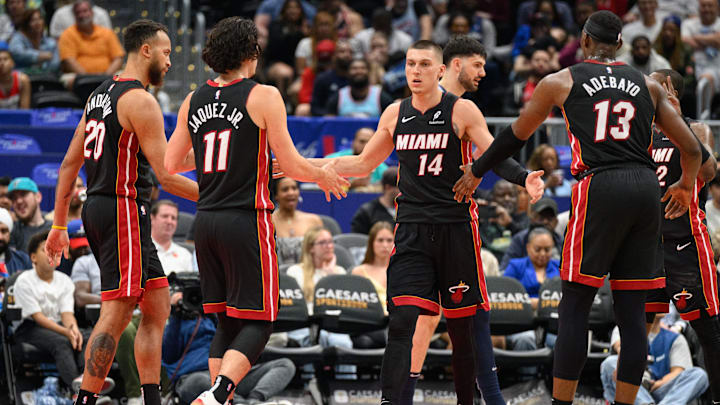 Mar 31, 2025; Washington, District of Columbia, USA; Miami Heat guard Tyler Herro (14) reacts with center Bam Adebayo (13), and guard Jaime Jaquez Jr. (11) during the third quarter against the Washington Wizards at Capital One Arena. Mandatory Credit: Reggie Hildred-Imagn Images
