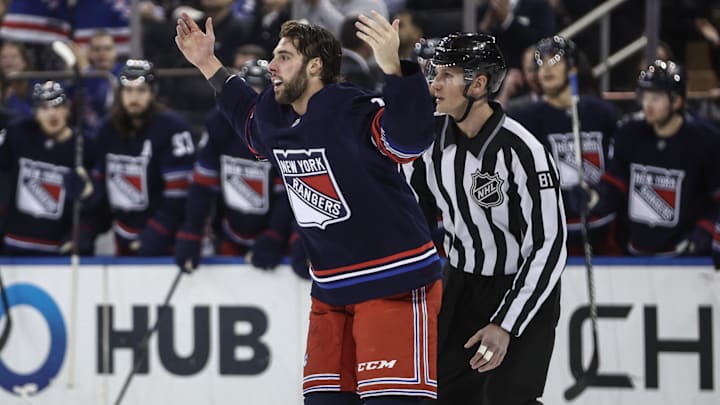 Dec 14, 2024; New York, New York, USA;  New York Rangers defenseman Connor Mackey (14) waves to the crowd in the first period after fighting against the Los Angeles Kings at Madison Square Garden. Mandatory Credit: Wendell Cruz-Imagn Images