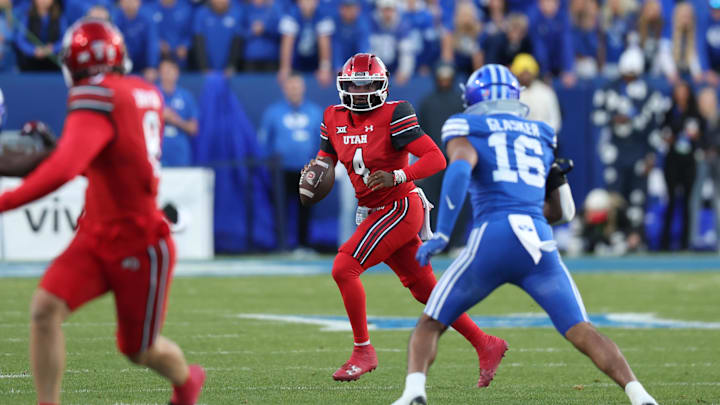 Utah Utes quarterback Devon Dampier (4) scrambles out of the pocket against the BYU Cougars during the first half at LaVell Edwards Stadium. Utah Utes quarterback Devon Dampier (4) scrambles out of the pocket against the BYU Cougars during the first half at LaVell Edwards Stadium.