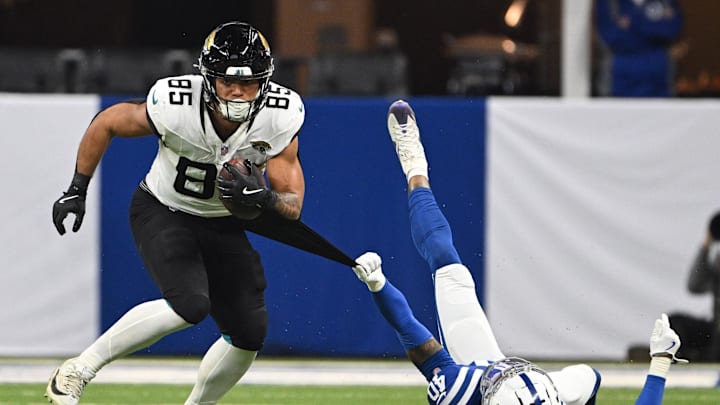Jan 5, 2025; Indianapolis, Indiana, USA; Indianapolis Colts cornerback Jaylon Jones (40) grabs the jersey of Jacksonville Jaguars tight end Brenton Strange (85) in an attempt to tackle during the second half at Lucas Oil Stadium. Mandatory Credit: Marc Lebryk-Imagn Images