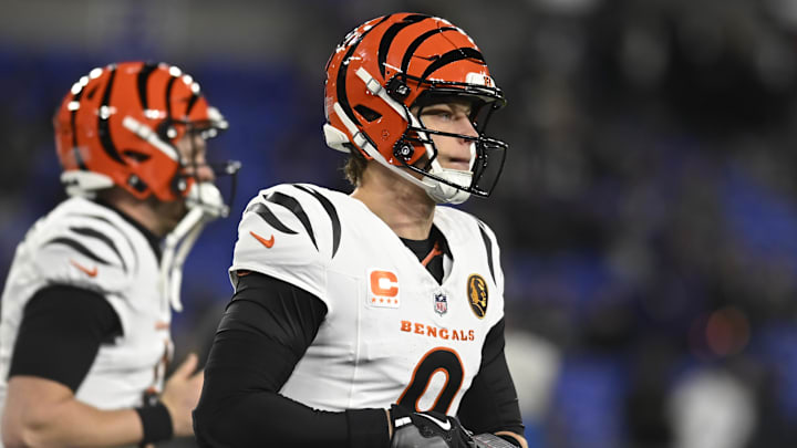 Nov 27, 2025; Baltimore, Maryland, USA;  Cincinnati Bengals quarterback Joe Burrow (9) adjust his gloves while running on the field before the game against the Baltimore Ravens at M&T Bank Stadium. Mandatory Credit: Tommy Gilligan-Imagn Images