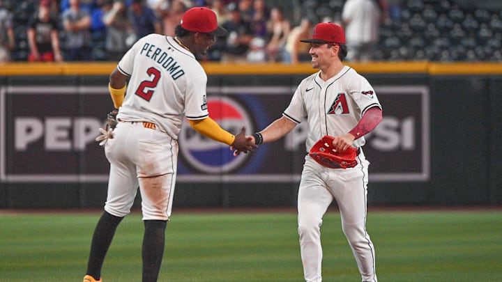 Apr 9, 2025; Phoenix, Arizona, USA;  Arizona Diamondbacks shortstop Geraldo Perdomo (2) celebrates with outfielder Corbin Carroll (7) after beating the Baltimore Orioles at Chase Field. Mandatory Credit: Matt Kartozian-Imagn Images