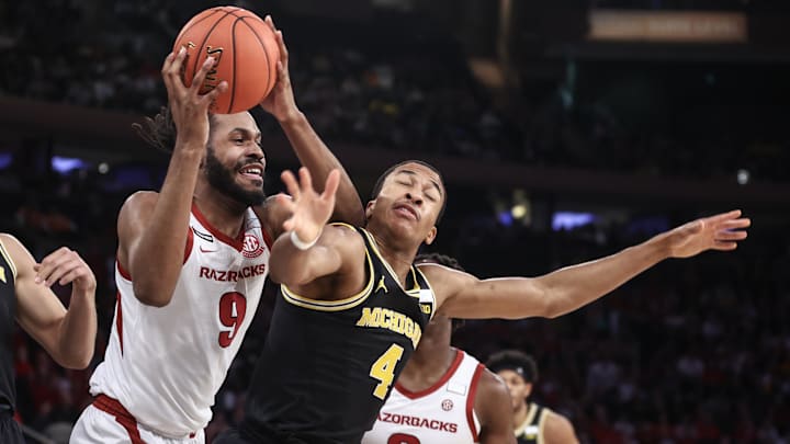Dec 10, 2024; New York, New York, USA;  Arkansas Razorbacks forward Jonas Aidoo (9) and Michigan Wolverines guard Nimari Burnett (4) fight for a loose ball in the first half at Madison Square Garden. Mandatory Credit: Wendell Cruz-Imagn Images