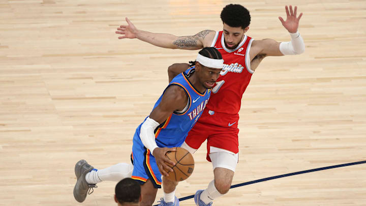 Apr 26, 2025; Memphis, Tennessee, USA; Oklahoma City Thunder guard Shai Gilgeous-Alexander (2) drives to the basket as Memphis Grizzlies guard Scotty Pippen Jr. (1) defends during the third quarter during game four for the first round of the 2024 NBA Playoffs at FedExForum. Mandatory Credit: Petre Thomas-Imagn Images
