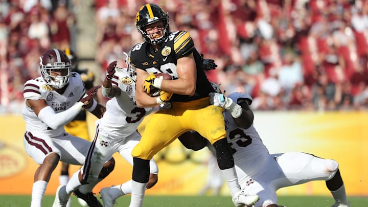 Jan 1, 2019; Tampa, FL, USA; Iowa Hawkeyes tight end T.J. Hockenson (38) runs with the ball as Mississippi State Bulldogs cornerback Cameron Dantzler (3) defends during the second half in the 2019 Outback Bowl at Raymond James Stadium. Mandatory Credit: Kim Klement-Imagn Images