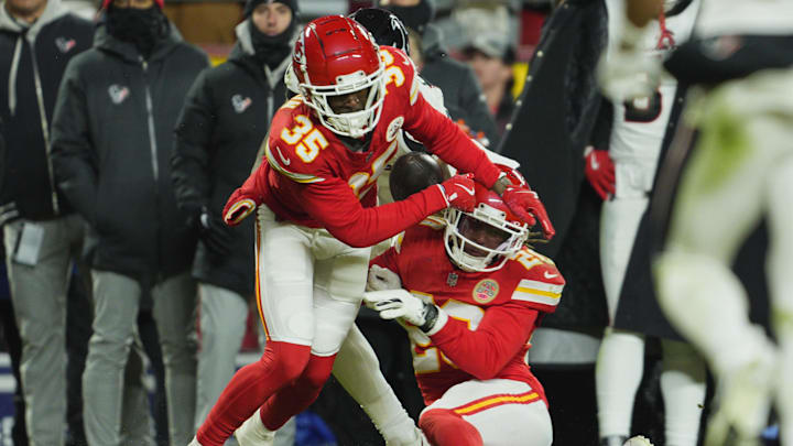 Jan 18, 2025; Kansas City, Missouri, USA; Kansas City Chiefs cornerback Jaylen Watson (35) and safety Justin Reid (20) break up a pass intended for Houston Texans wide receiver Nico Collins (12) during the fourth quarter of a 2025 AFC divisional round game at GEHA Field at Arrowhead Stadium.