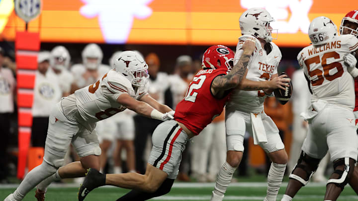 Dec 7, 2024; Atlanta, GA, USA; Georgia Bulldogs linebacker Chaz Chambliss (32) sacks Texas Longhorns quarterback Quinn Ewers (3) during the first half in the 2024 SEC Championship game at Mercedes-Benz Stadium. Mandatory Credit: Brett Davis-Imagn Images