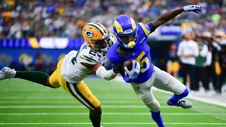 Oct 6, 2024; Inglewood, California, USA; Los Angeles Rams wide receiver Tutu Atwell (5) runs the ball against Green Bay Packers cornerback Carrington Valentine (24) during the second half at SoFi Stadium. Mandatory Credit: Gary A. Vasquez-Imagn Images