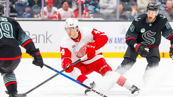 Oct 20, 2026; Seattle, Washington, USA; Detroit Red Wings defenseman Axel Sandin-Pellikka (44) skates with the puck against the Seattle Kraken during the first period at Climate Pledge Arena. Mandatory Credit: Joe Nicholson-Imagn Images