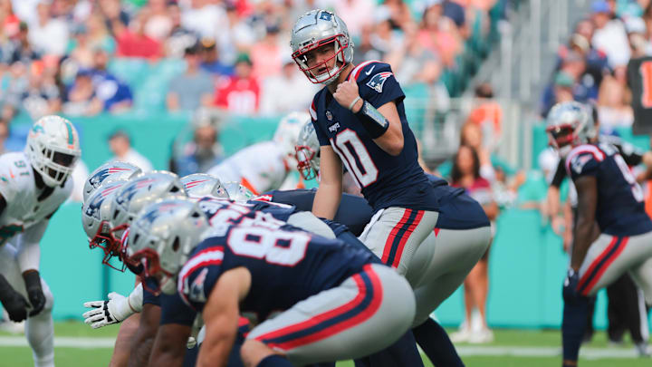 Nov 24, 2024; Miami Gardens, Florida, USA; New England Patriots quarterback Drake Maye (10) reacts from the line of scrimmage against the Miami Dolphins during the first quarter at Hard Rock Stadium. Mandatory Credit: Sam Navarro-Imagn Images