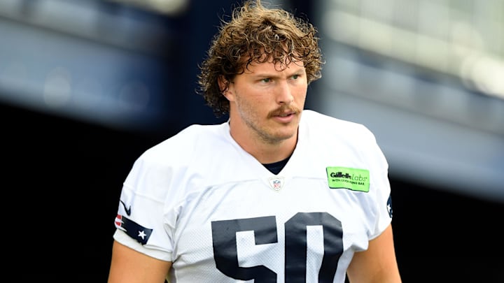 Jul 29, 2022; Foxborough, MA, USA; New England Patriots offensive lineman Cole Strange (50) walks onto the field before training camp at Gillette Stadium. Mandatory Credit: Brian Fluharty-Imagn Images