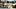 A paddle boat goes by the tailgate area of the stadium boat basin A paddle boat goes by the tailgate area of the stadium boat basin