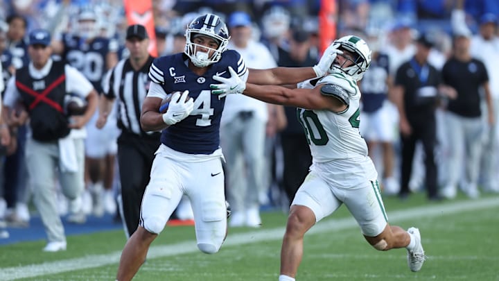 Aug 30, 2025; Provo, Utah, USA; Brigham Young Cougars running back LJ Martin (4) runs the ball against Portland State Vikings linebacker Lonnie Burt (40) during the second quarter at LaVell Edwards Stadium. Mandatory Credit: Rob Gray-Imagn Images