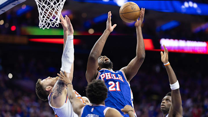 May 2, 2024; Philadelphia, Pennsylvania, USA; Philadelphia 76ers center Joel Embiid (21) reaches for a rebound against New York Knicks center Isaiah Hartenstein (55) during the second half of game six of the first round for the 2024 NBA playoffs at Wells Fargo Center. Mandatory Credit: Bill Streicher-Imagn Images