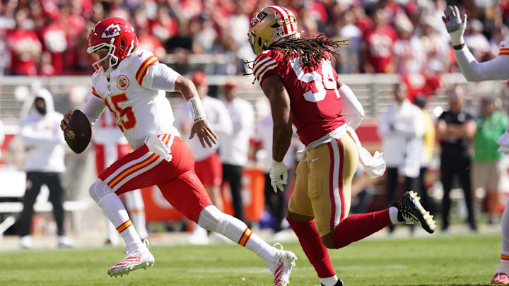 Oct 20, 2024; Santa Clara, California, USA; Kansas City Chiefs quarterback Patrick Mahomes (15) runs past San Francisco 49ers linebacker Fred Warner (54) in the first quarter at Levi's Stadium. Mandatory Credit: Cary Edmondson-Imagn Images