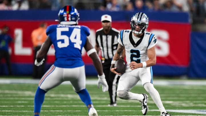 Aug 18, 2023; East Rutherford, New Jersey, USA; Carolina Panthers quarterback Matt Corral (2) tries to get past New York Giants linebacker Dyontae Johnson (54) during the third quarter at MetLife Stadium.  