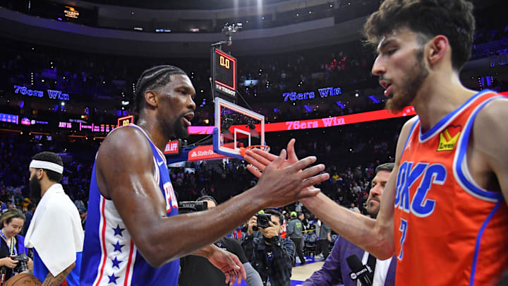 Apr 2, 2024; Philadelphia, Pennsylvania, USA; Philadelphia 76ers center Joel Embiid (21) and Oklahoma City Thunder forward Chet Holmgren (7) meet on court after 76ers win at Wells Fargo Center. Mandatory Credit: Eric Hartline-Imagn Images